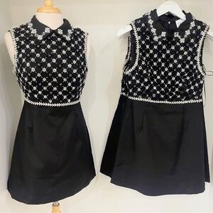Beautifully beaded collared black mini dress.